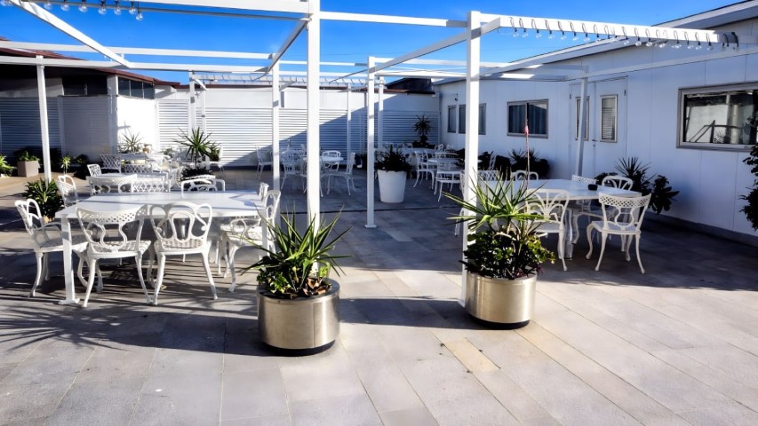 Terraza exterior con pérgola y piscina para eventos al aire libre