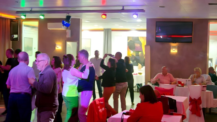 Pista de baile llena de gente en evento nocturno del Hotel Ruta Romana