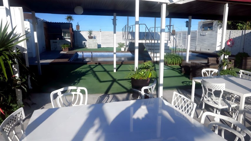 Vista panorámica de la sala con múltiples mesas y sillas con lazos rojos