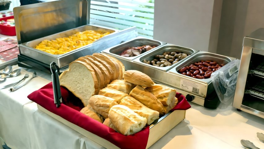 Zona caliente con huevos revueltos, embutidos y pan fresco